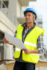 Construction manager checking building site