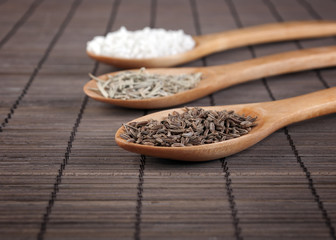 various spices in wooden spoons