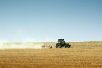 Tractor plowing field