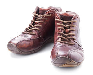 A pair of old brown boots isolated on white