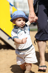 Baby walking with mother's assistance