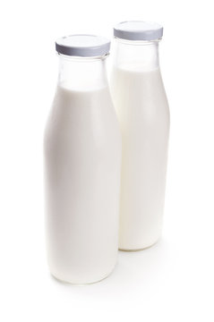 two milk bottles isolated on white