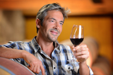 Winemakers in cellar using electronic tablet