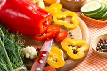 Fresh yellow and red pepper on the wooden board
