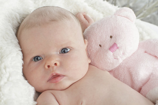 Sweet baby with pink teddy bear