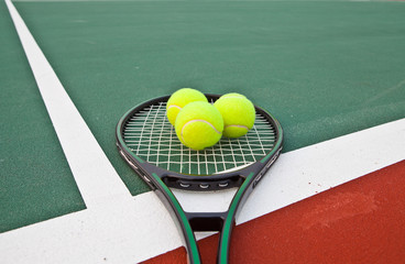 Tennis court with balls and racket