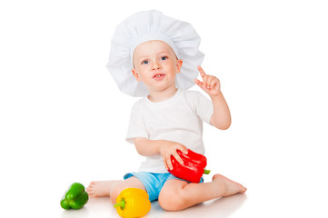 Boy in chef hat with pepper