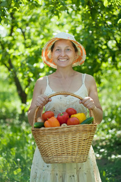 Happy woman with vegetables harvest