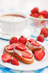 French toasts with powdered sugar and a strawberry