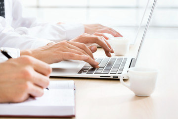 Business woman typing on laptop keyboard