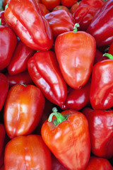 Red sweet bell peppers natural background.