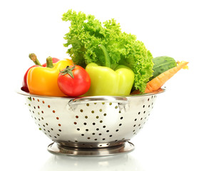 fresh vegetables in silver colander isolated on white