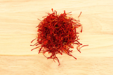 Fototapeta premium stigmas of saffron on wooden background close-up