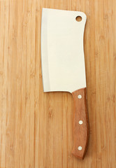 meat cleaver on wooden background close-up