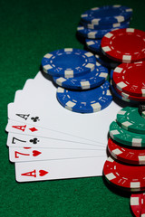 Cards and chips for poker on green table