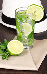 Mojito and a hat on a wooden background