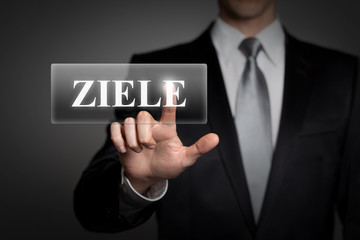Mann drückt touchscreen button - Ziele