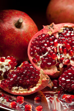 Pomegranate slices and seeds on silver tray