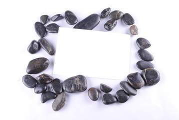 black zen stones and a white card, soft shadows