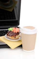 Eating at work place near laptop