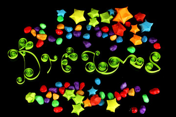 The word Dreams with colorful paper stars with dreams isolated