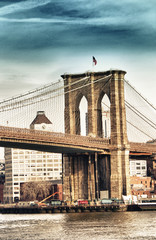 Portrait view of Brooklyn Bridge Tower and flag in New York City