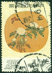stamp  shows Chinese painting of butterfly and a flower