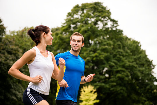 Running together - young couple jogging