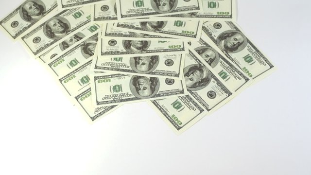 Hundred dollar banknotes appear and disappear from screen