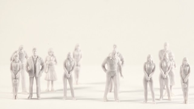 White miniatures of men and women appear on screen