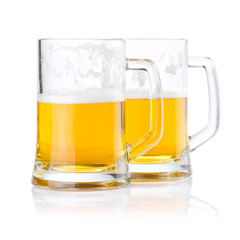 Two half glasses of fresh beer with foam isolated on white backg