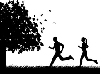 Girl and man running in park in autumn or fall silhouette