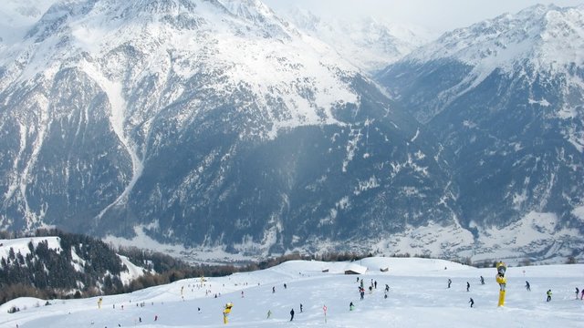 Many skiers go down to mountain bottom