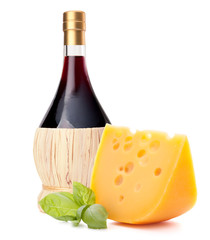 Red wine bottle, cheese and basil leave still life