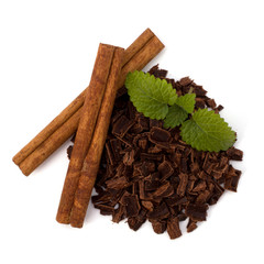 Crushed chocolate shavings pile and cinnamon sticks
