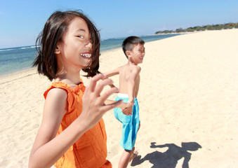 kids running in the beach
