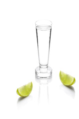shot glass filled with clear cold alcohol isolated on white