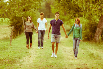 Fototapeta premium Group of Teenagers Walking Holding Hands