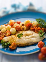 cod with onions and tomatoes sauce, selective focus