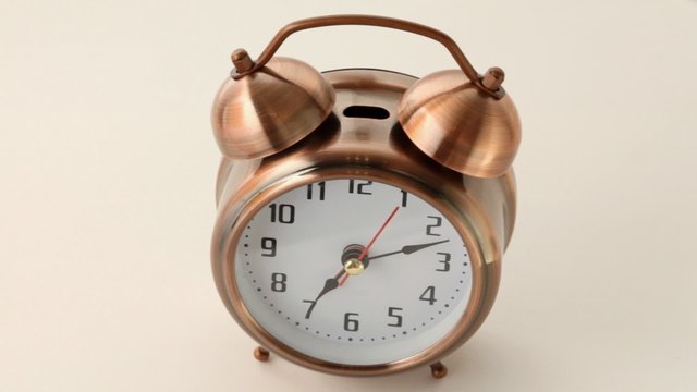 old fashioned round alarm clock from copper rotates