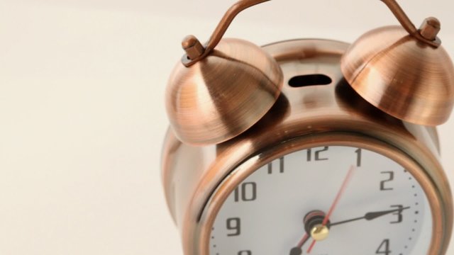 copper alarm clock calls and rotates on circle