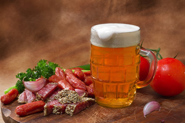 Still life with beer and salami