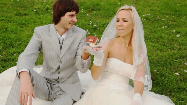 groom gets breadboard model of house and gives to its bride
