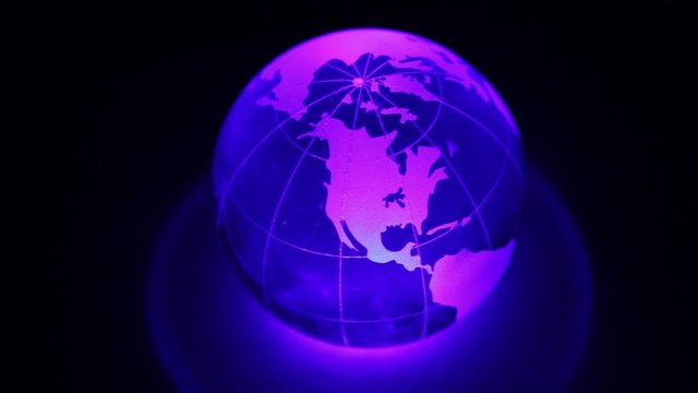 Sphere spins with world map on it and color illumination