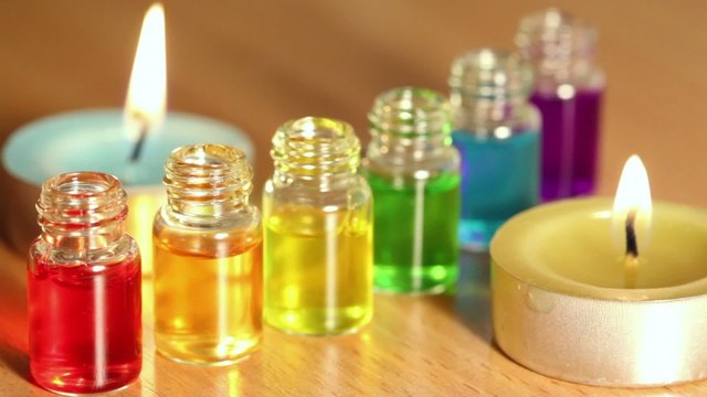 candles burns, and bottles with color oil circling