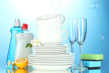 empty clean plates, glasses and cups with dishwashing liquid,