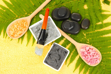 cosmetic clay for spa treatments on yellow background close-up