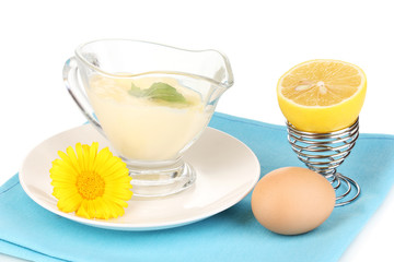 Mayonnaise in bowl on napkin isolated on white
