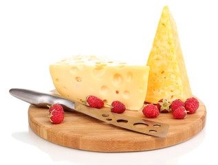 tasty cheese and berries on wooden board isolated on white