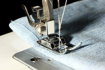 Sewing machine with jeans closeup